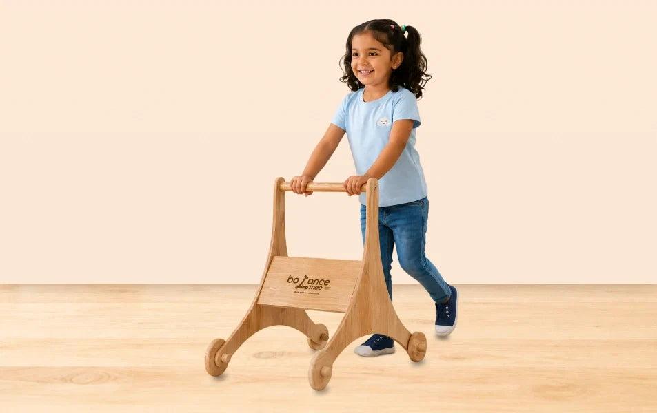 Boy outdoors using wooden Balance mee Montessori balance board on park path