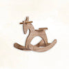 Handcrafted wooden Montessori rocking horse toy on a plain background