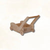 Handcrafted wooden Montessori push toy cart with wheels, natural finish, on white background