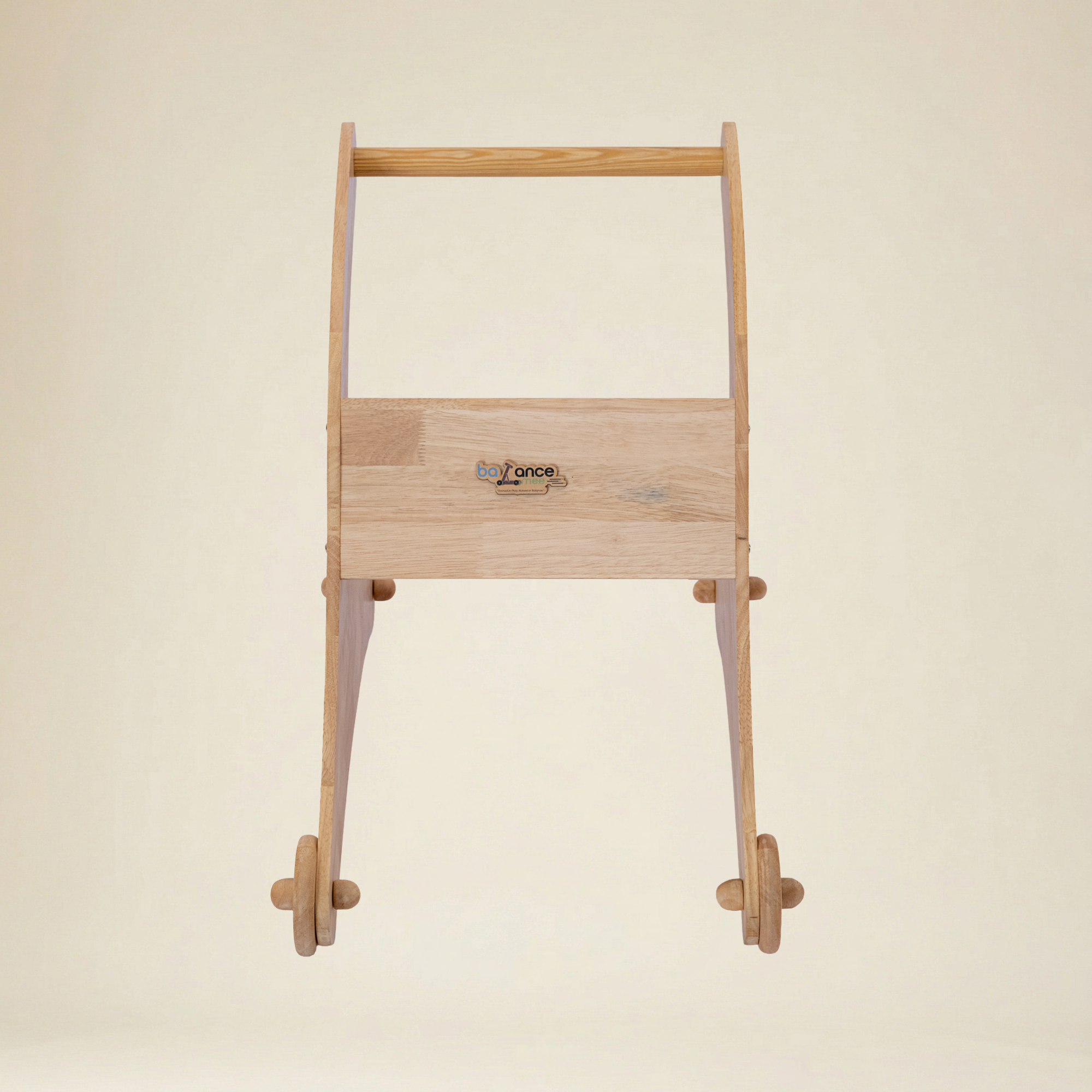 Toddler practicing first steps using a safe wooden shark walker
