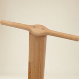 Child engaged in creative play with a wooden pull-along wagon