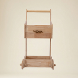 Toddler engaged in Montessori role play with a wooden toy cart