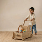Side view of the car-shaped wooden walker showing the sturdy handle