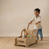 Side view of the car-shaped wooden walker showing the sturdy handle