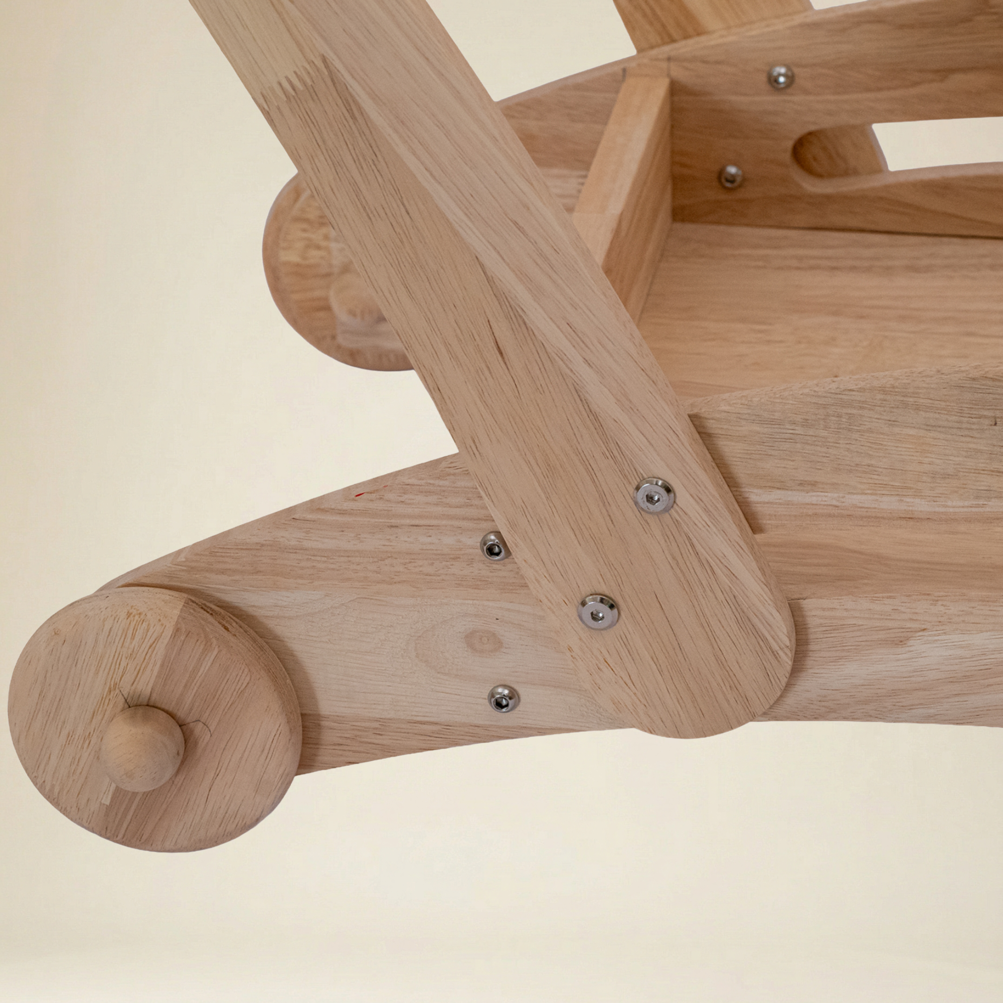 Toddler practicing first steps with a safe wooden toy cart walker